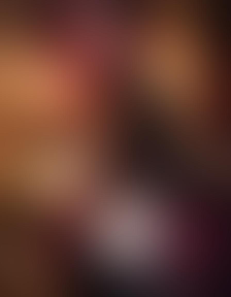 A sensual, intimate setting featuring two silhouettes intertwined in a passionate embrace, surrounded by warm, soft lighting. Include elements like silk sheets, candles, and intimate accessories to create an inviting atmosphere. The color scheme should blend deep reds and purples to evoke desire and intimacy. In the background, subtle hints of abstract shapes suggesting exploration and discovery. super-realistic. vibrant colors. soft lighting.